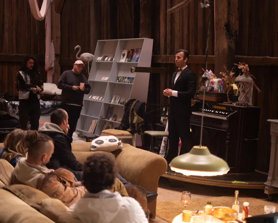 Guests gathered on sofas in the timber barn lounge for a speech