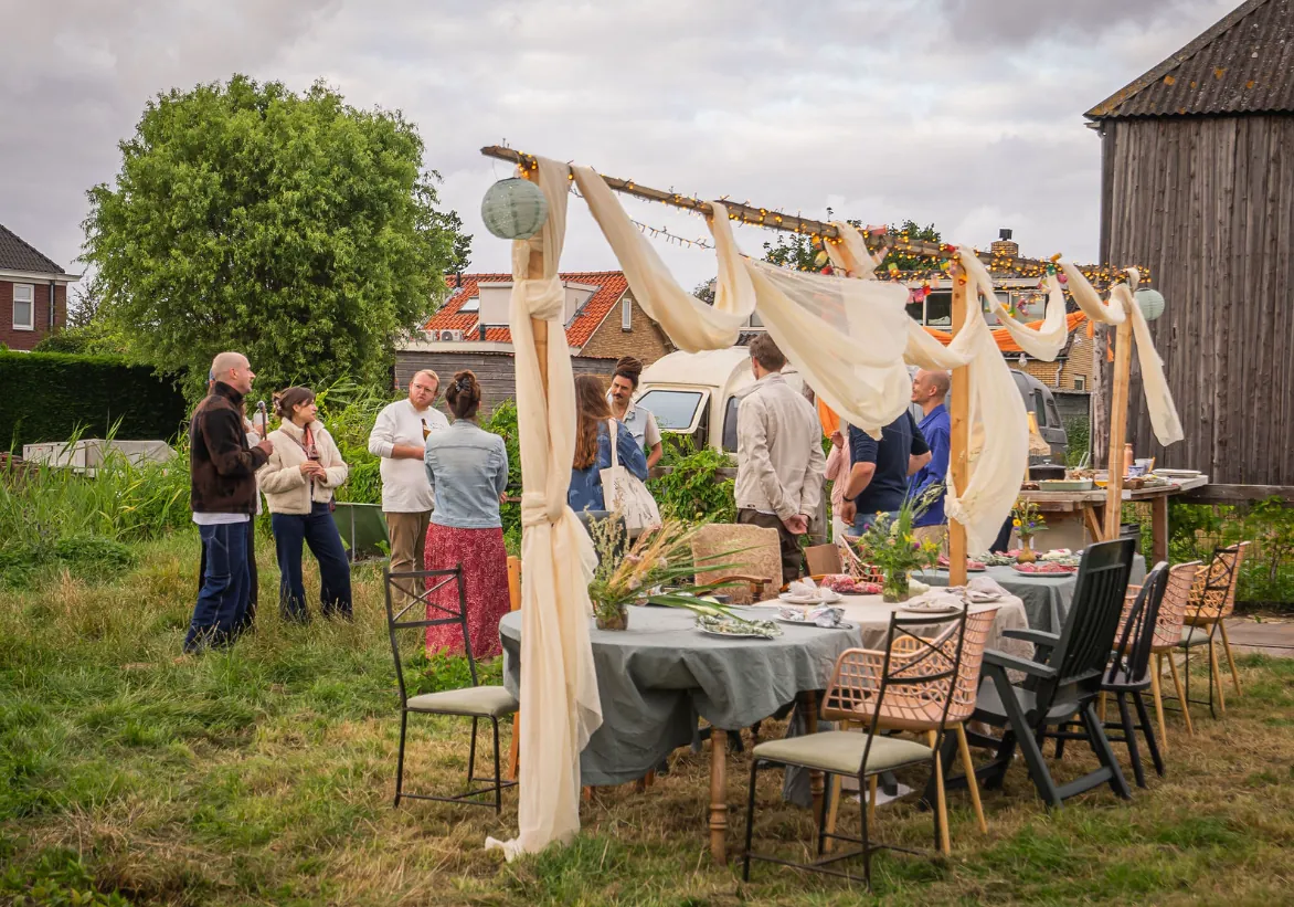 Long table set beneath billowing linen drapes in the garden